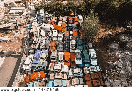 Aerial View Of A Soviet Automobile Dump From A Drone. Shooting From Above At Heaps Of Rusty Cars. Ab