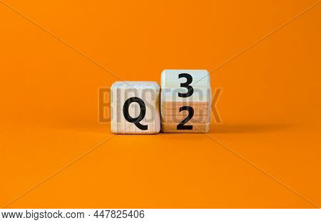 From 2nd To 3rd Quarter Symbol. Turned A Wooden Cube And Changed Words 'q2' To 'q3'. Beautiful Orang
