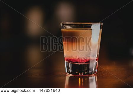 Brain Hemorrhage Tornado In Shot Alcohol Drink Based On Cream, Liqueur And Grenadine With Baileys