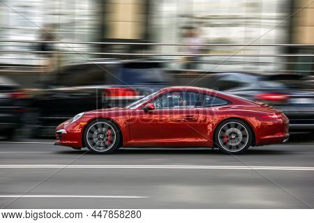 Kiev, Ukraine - June 19, 2021: Red Supercar Porsche 911 In Motion. High Speed. Porsche In The City