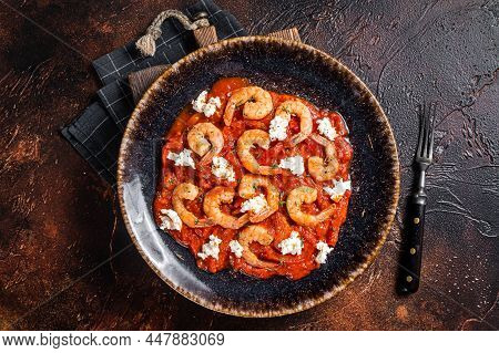 Saganaki Shrimp Prawns With Tomato And Feta Cheese On A Plate. Dark Background. Top View.