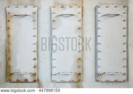 Three Metal Hatches Plates On Compressor For Revision Close-up With Oil Stains Painted With Gray Pai