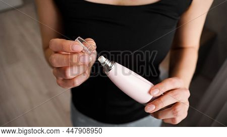 Vacuum Blackhead Remover In Woman Hand, Cosmetic Beauty Procedure At Home. Woman Changes The Nozzle 