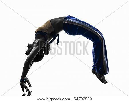 one caucasian woman capoeira dancer dancing backflip in silhouette studio on white background