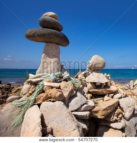 Stone figures on beach shore of Illetes beach in Formentera Mediterranean Balearic Islands
