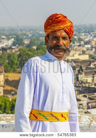 Rajasthani Man With Bright Red Turban And Bushy Mustache Poses For Tourists