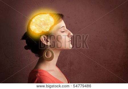 Young girl thinking with glowing brain illustration on grungy background