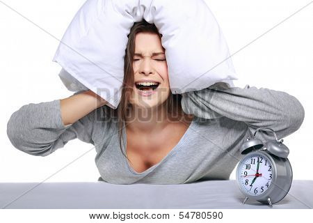 happy positive young  woman waking up and switching off the alarm clock