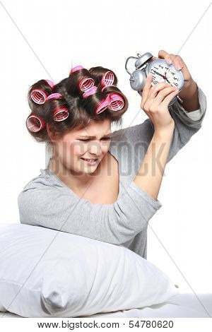 happy positive young  woman waking up and switching off the alarm clock