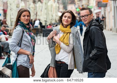 Portrait of traveling friends on shopping street