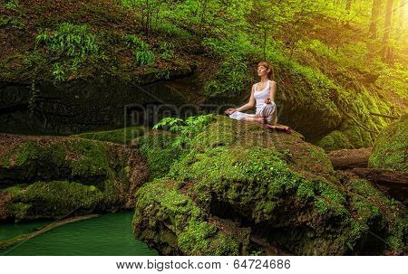 Relaxation in forest at the Waterfall. Ardha Padmasana pose