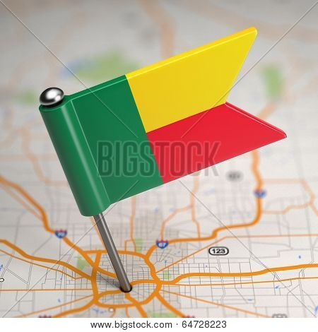 Benin Small Flag on a Map Background.