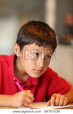 Young boy drawing for homework