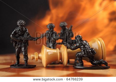 Toy soldiers kill chess King in fire.
