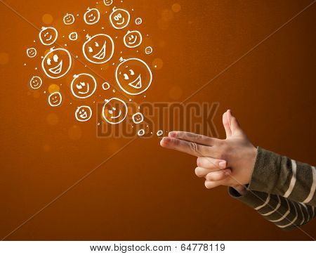 Group of happy hand drawed smiley faces coming out of gun shaped hands
