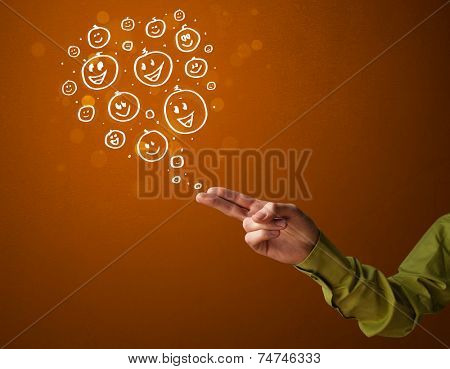 Group of happy hand drawed smiley faces coming out of gun shaped hands