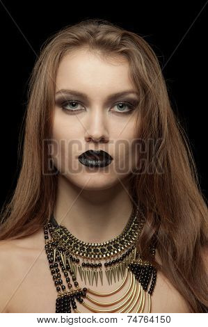 Closeup portrait of a gothic young woman with black lips