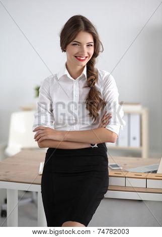 Attractive businesswoman with her arms crossed stnding