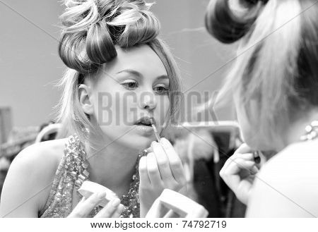 portrait photo of girl doing make up. black and white photography