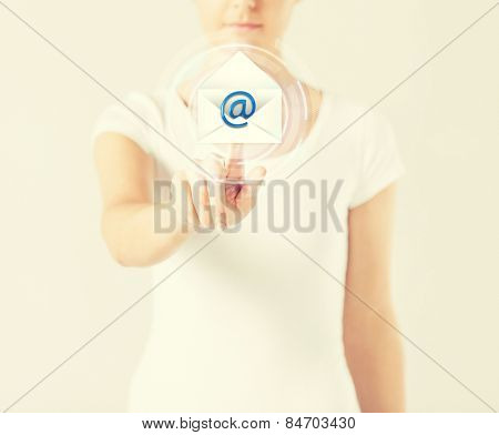 close up woman pressing virtual button with e-mail icon