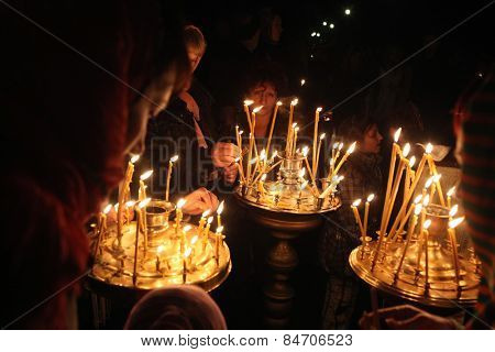PRAGUE, CZECH REPUBLIC - MAY 5, 2013: Orthodox believers light candles during an Orthodox Easter night service in front of the Dormition Church at the Olsany Cemetery in Prague, Czech Republic.
