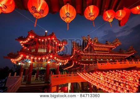 KUALA LUMPUR, MALAYSIA - FEBRUARY 23, 2015: Tourists visit the scenic Thean Hou Temple at night with hundreds of lanterns hung across the courtyard celebrating the lunar Chinese New Year.