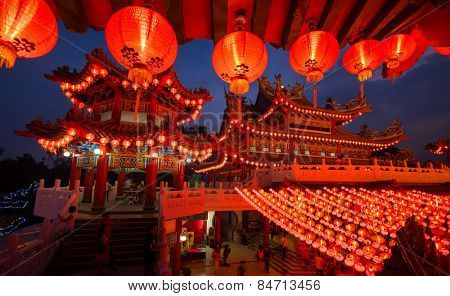 KUALA LUMPUR, MALAYSIA - FEBRUARY 23, 2015: Tourists visit the scenic Thean Hou Temple at night with hundreds of lanterns hung across the courtyard celebrating the lunar Chinese New Year.