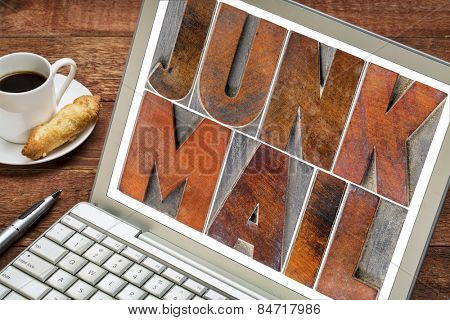 junk mail - text in letterpress wood type blocks on a laptop screen
