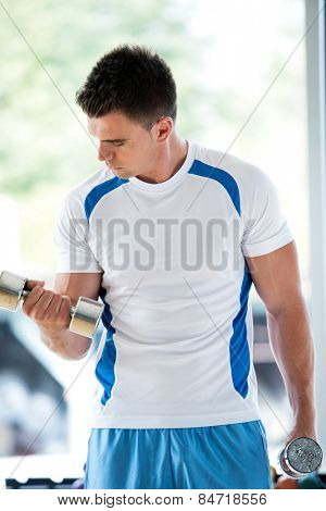 young man in fintess sport club exercise with weights and relaxing