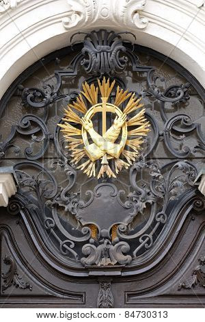 GRAZ, AUSTRIA - JANUARY 10, 2015: Franciscan monogram on the main entrance, Mariahilf church in Graz, Styria, Austria on January 10, 2015.