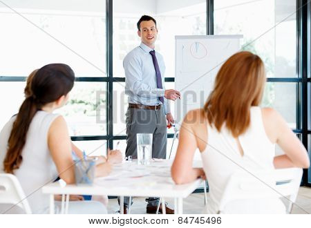 Businessman doing a presentaion in front of his collegues