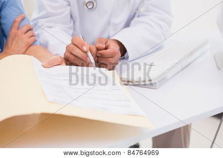 Doctors looking at files in medical office