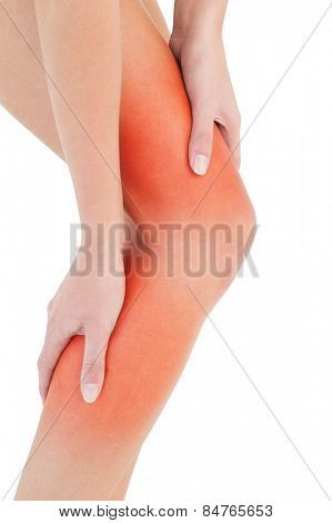 Closeup mid section of a fit young woman with leg pain over white background