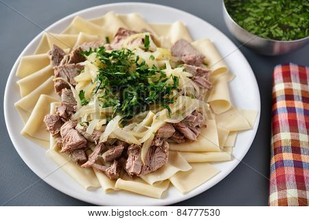 Traditional dish of Turkic people in Central Asia Beshbarmak. Focus on the greens