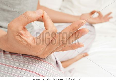 young man meditating with his hands in gyan mudra