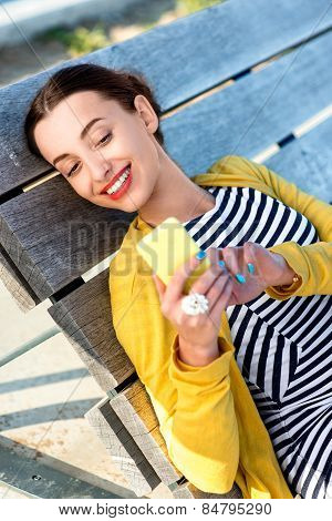 Woman with phone on sunbed
