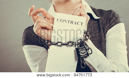 Businesswoman With Chained Hands Holding Contract