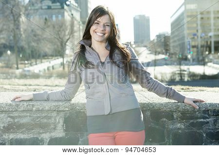 young beauty posing over city background