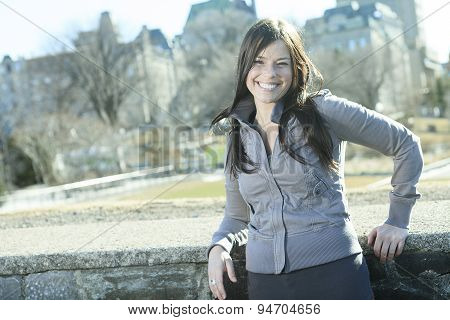 young beauty posing over city background