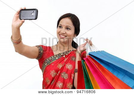 Traditional Indian Woman With Shopping Bags And Take Selfie