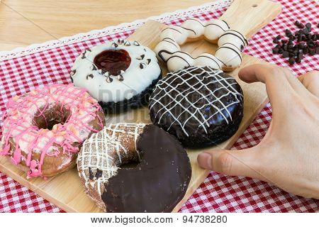 Hand Taking Doughnut Or Donut During Coffee Break