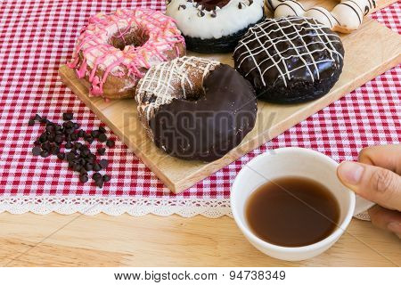 Hand Holding Cup Of Coffee During Doughnut Or Donut Coffee Break