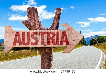 Austria wooden sign with road background
