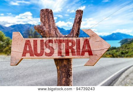 Austria wooden sign with road background
