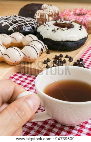 Hand Holding Cup Of Coffee During Doughnut Or Donut Coffee Break
