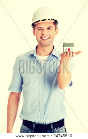 A forewoman holding a model house in hand