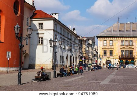 Krakow, Poland - March 07 2015: Unidentified Tourists Visiting Small Market Square In Krakow, Poland