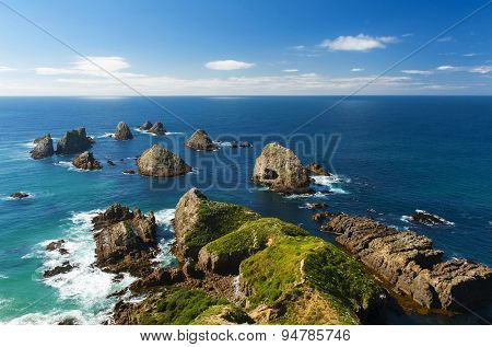 Nugget Point is located in the Catlins area on the Southern Coast of New Zealand, Otago region. The area is famous for many rock islands - nuggets - in the sea. 