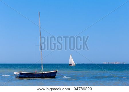 Calm blue sea with sailboats