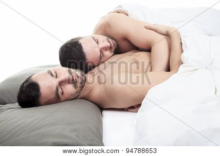 A homosexual couple onder a bed in studio white